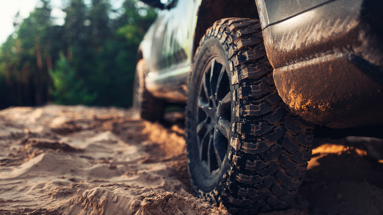 A close-up of a car tire on an off-roading route