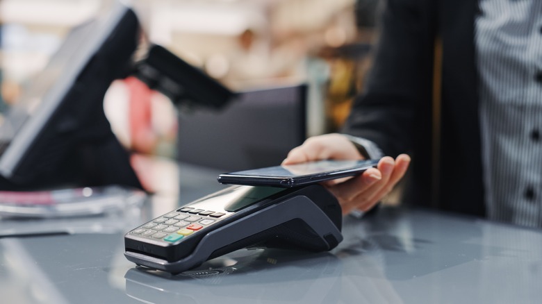 woman uses NFC mobile payment