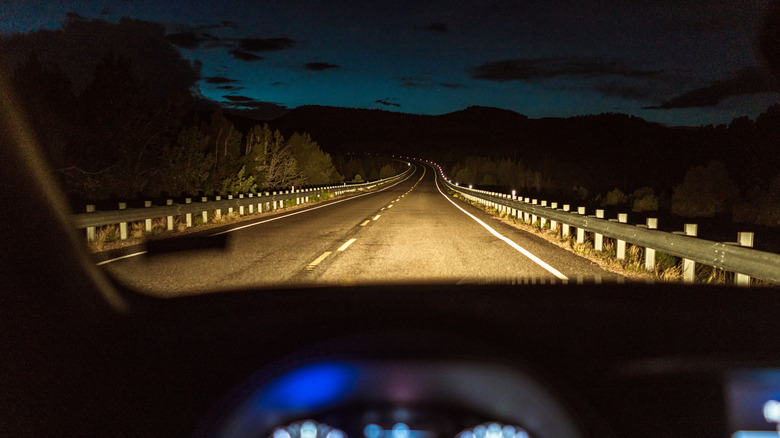 Car driving down a road at night