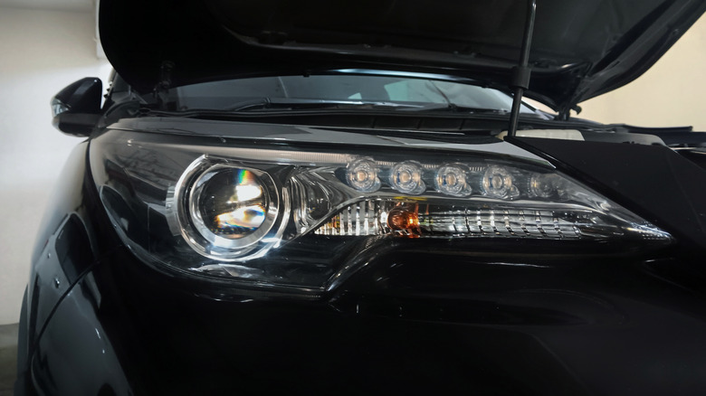 Modern car with LED driving lights and projector headlights