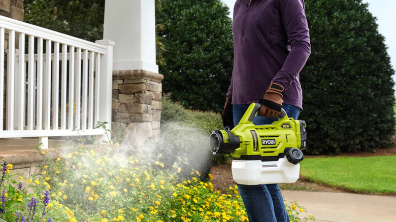 A woman using a Ryobi electrostatic sprayer