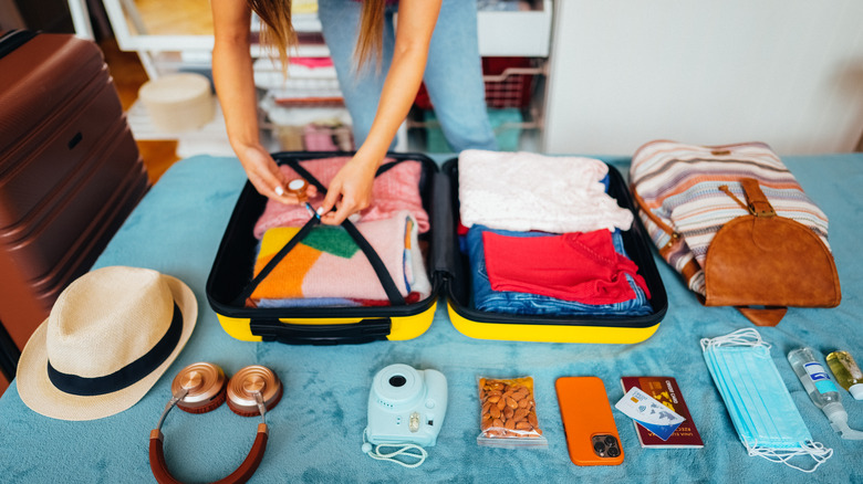 woman packing suitcase