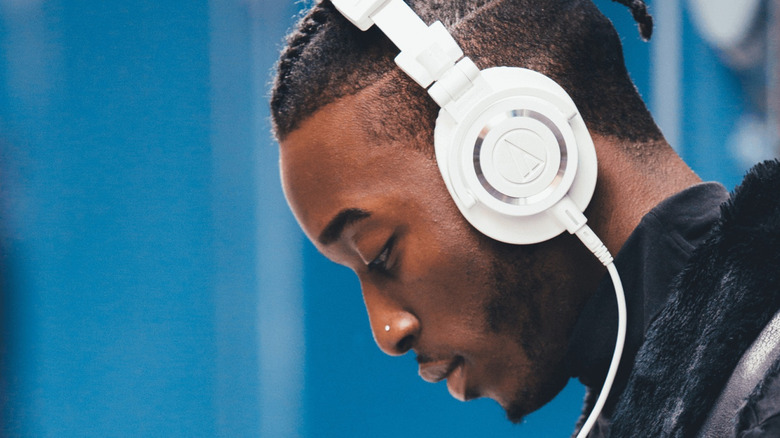 Man wearing Audio Technica ATH-M50x headphones