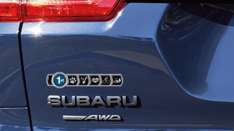 Subaru badge of ownership stuck on a blue Subaru
