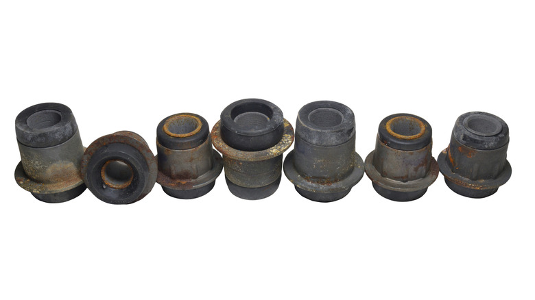A set of worn bushings for a car
