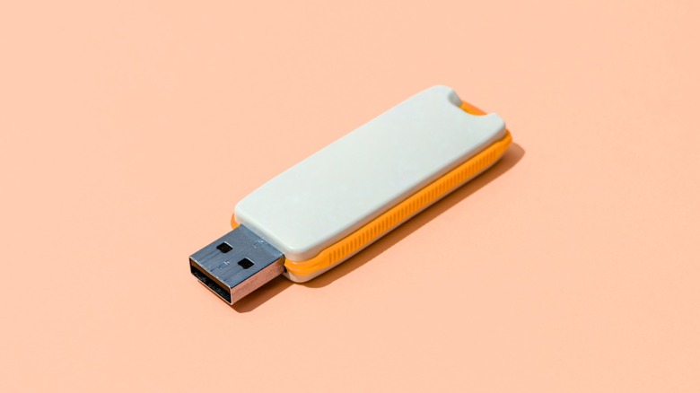 A USB flash drive with two square holes on the connector
