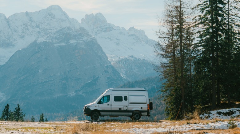 A Class B motorhome parked with an epic view of the mountains.