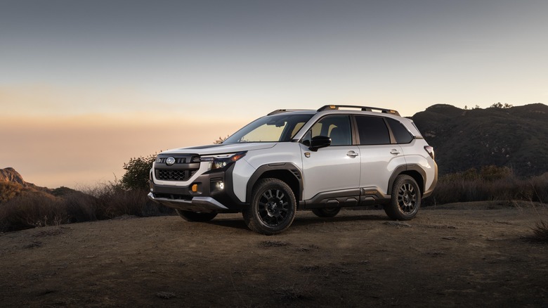 The 2025 Subaru Forester Wilderness in white with black wheels, front 3/4 view