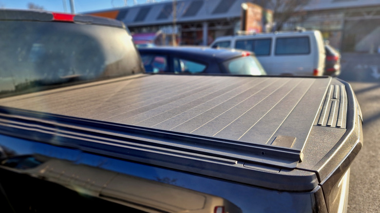 Hard tonneau cover over a truck bed