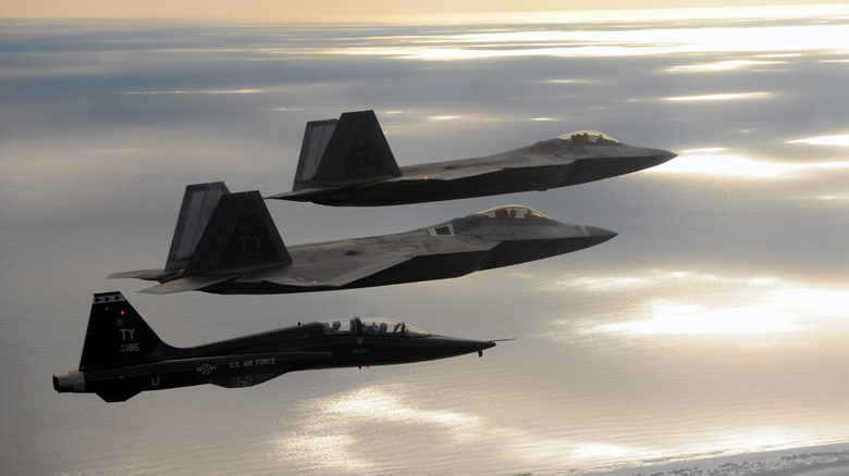 A formation of three fighter jets during a formation, overcast sky in the background