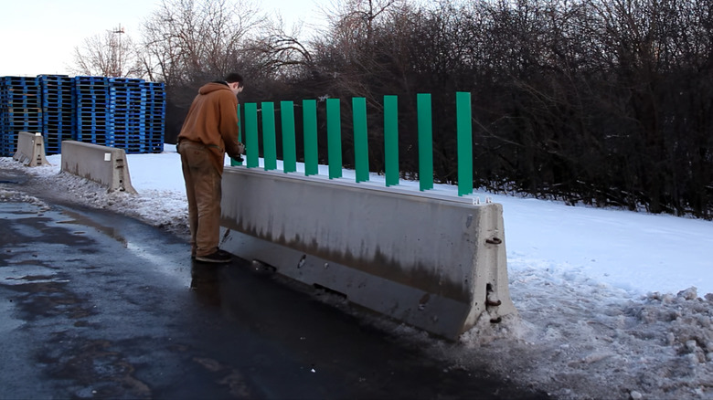 Man installing green colored highway glare shields