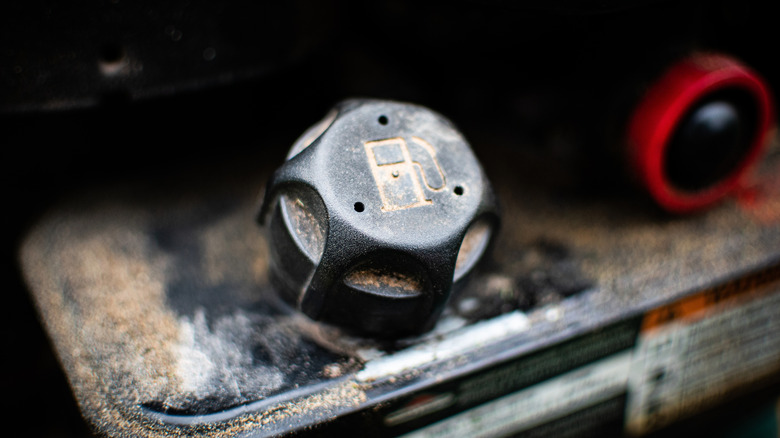 Close-up of the fuel cap on the gas tank of a gas powered lawn mower