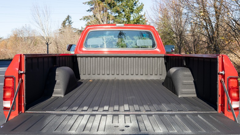 The truck bed on a red pickup truck, tailgate open