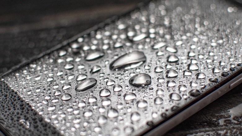 Smartphone covered in water droplets