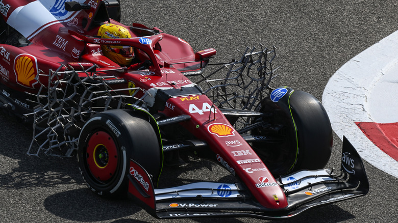 A close-up of a Ferrari F1 car showing the aero rakes
