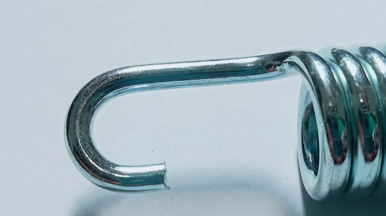 Close-up of motorcycle exhaust spring.