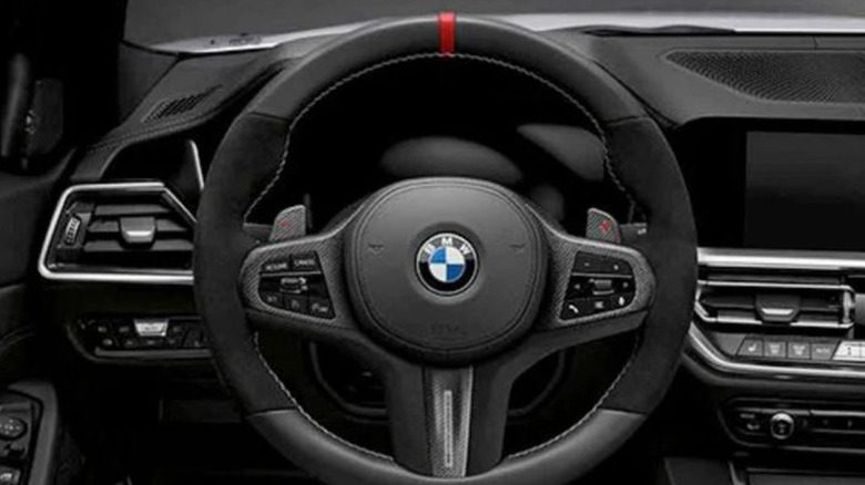 A BMW steering wheel with a red stripe.