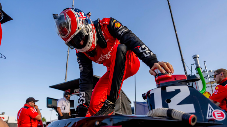 IndyCar driver with helmet tube in the foreground