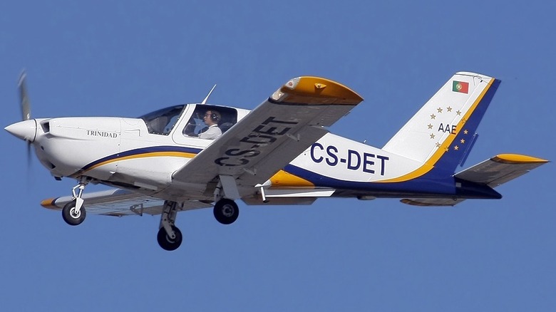 Socota TB-20 Trinidad GT in the air bearing Portuguese flag