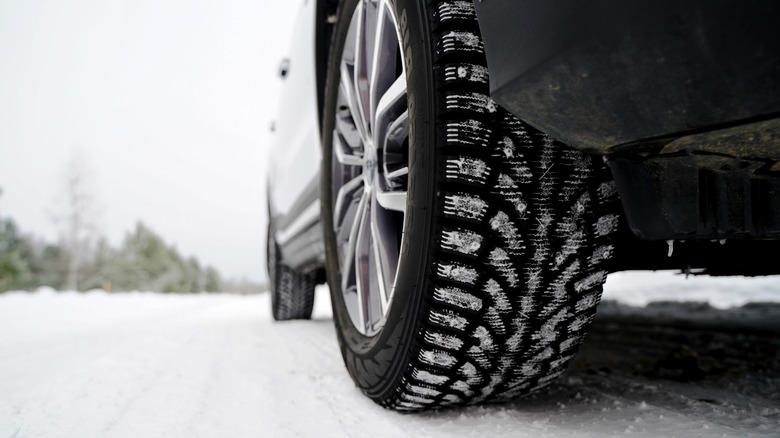 Knobby snow tire on a car traversing snow