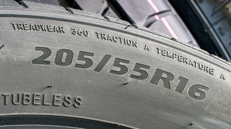 Closeup of tire sidewall showing UTQG treadwear, traction, and temperature ratings