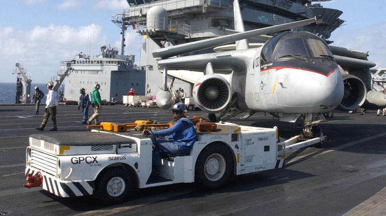 Aircrat tow tractor tows military aircraft