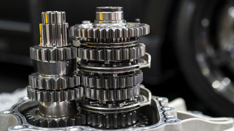 Close-up of manual transmission showing straight-cut gears and synchronizer rings assembled as a unit