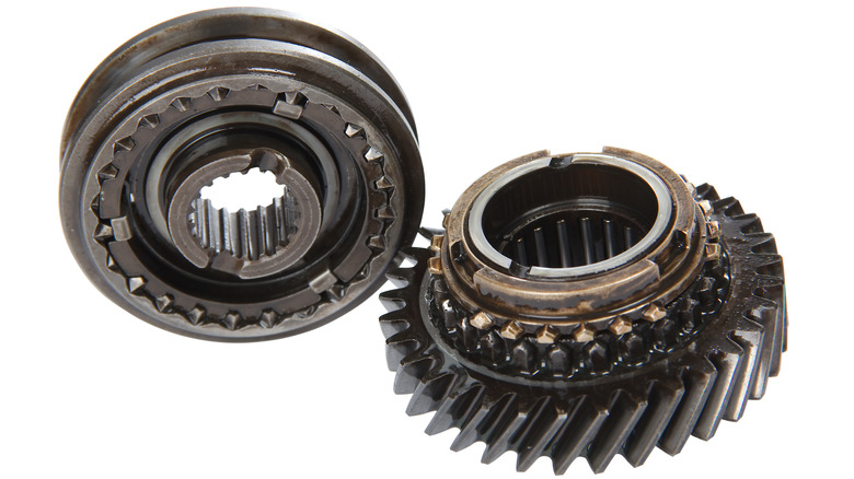Gear synchronizer and brass collar components on gear, shown on white background