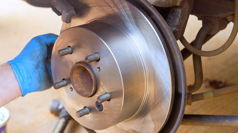 A mechanic installing a brake rotor.