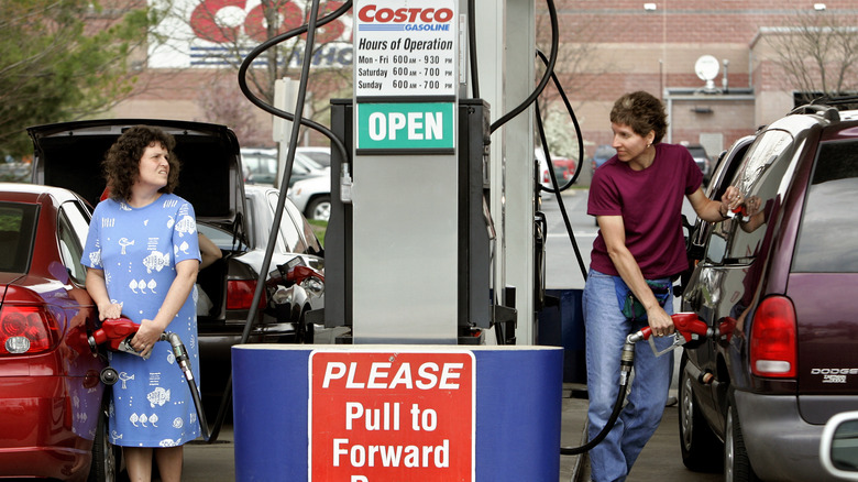 Costco members fill up on gas at the wholesale company's gas pumps