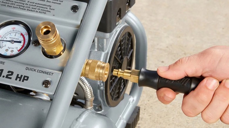 Plugging an air hose into a Fortress air compressor from Harbor Freight.