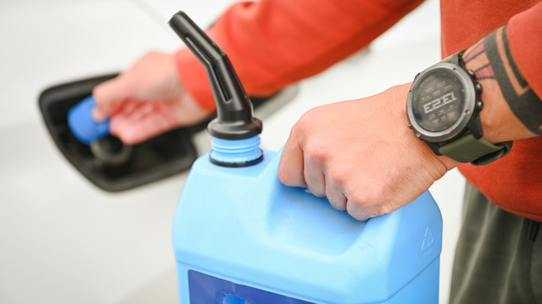 A person refilling DEF