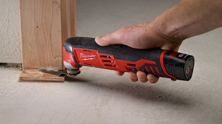Oscillating tool cutting door jam