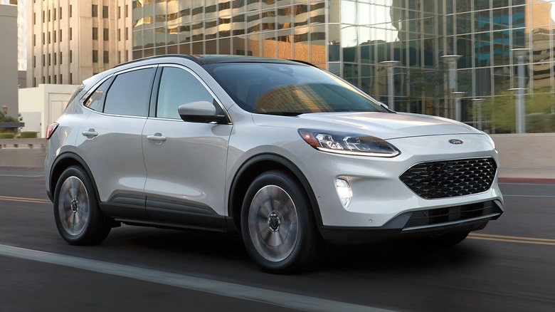White 2022 Ford Escape driving on a city road