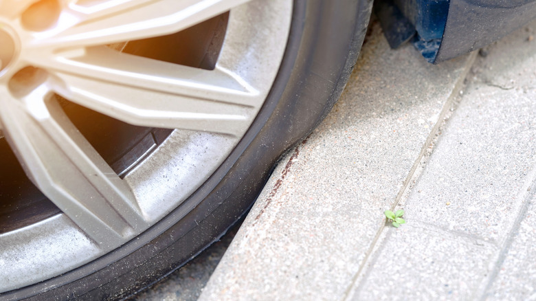 Tire pressing against curb