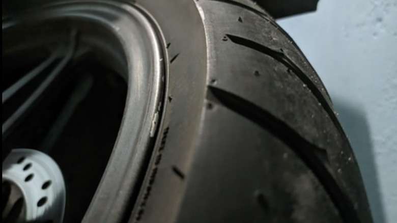 Close-up of a sports motorcycle tire showing an unworn area on the edge of the tread.