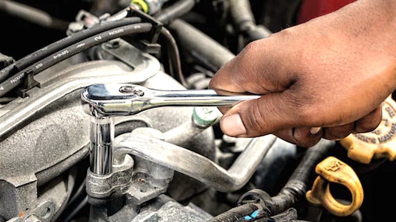 Mechanic using DeWalt tools on thier car