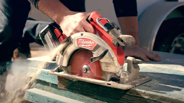Person using Milwaukee circular saw