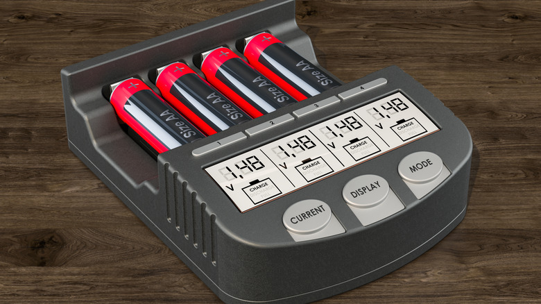 Battery charger charging four AA batteries