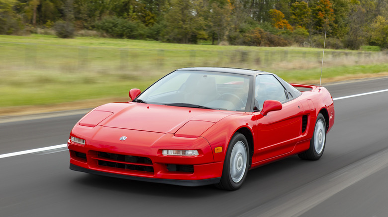 Red 1991 Acura Integra driving on a road