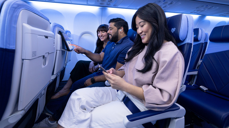 Passengers sitting in seats on a jet.