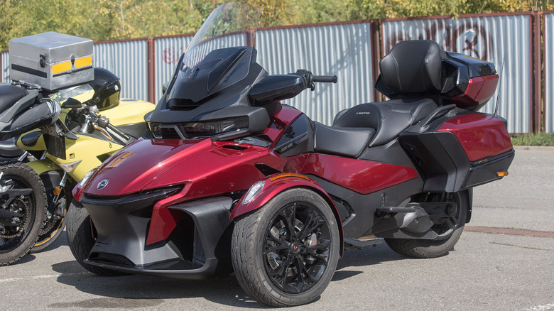 A red Can Am Spyder RT with black accents, front 3/4 view