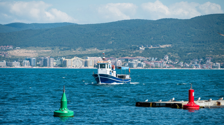 Boat approaching green and red buoys.