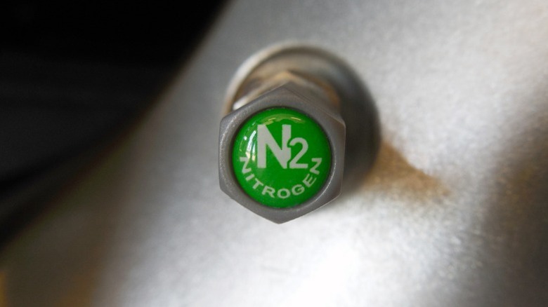 a closeup image of a green nitrogen valve stem cap