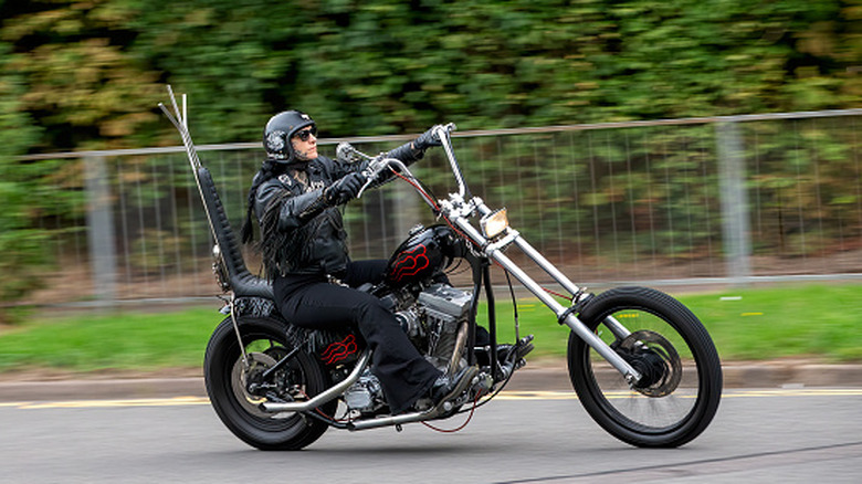 man riding harley davidson with high handlebars
