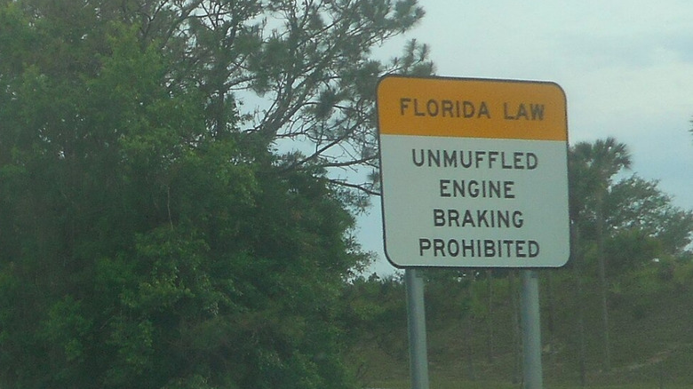 "Unmuffled Engine Braking Prohibited" sign on. a Florida road