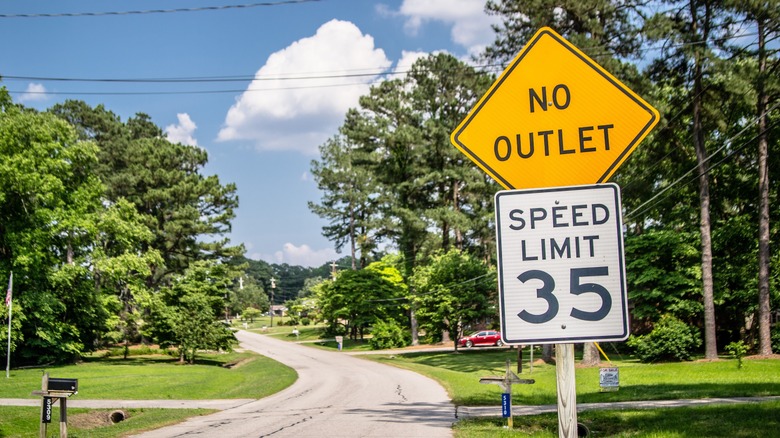 A No Outlet and Speed Limit 35 sign leading into a small neighborhood.