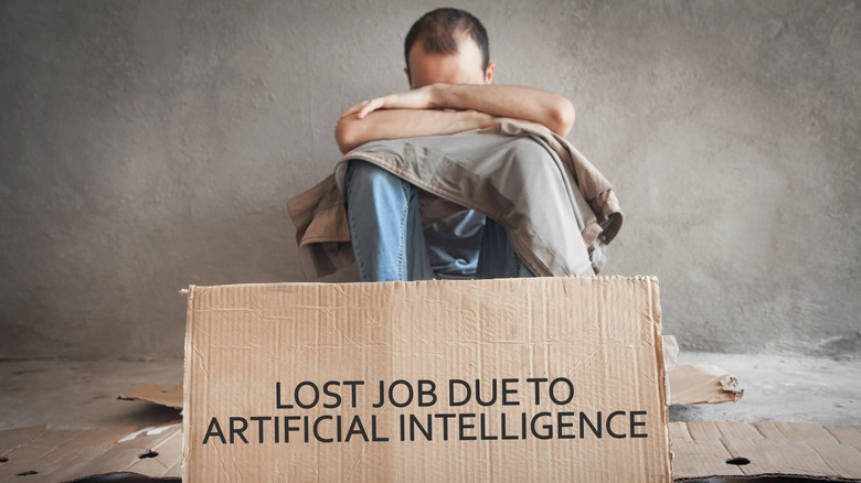 A man weeps behind a sign stating that he lost his job due to AI.
