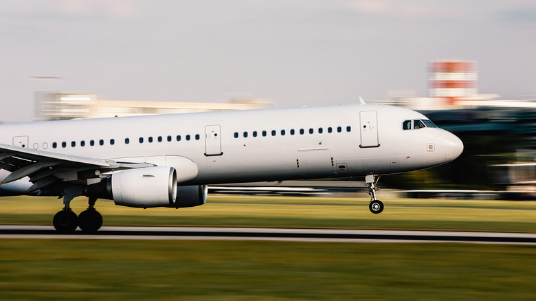 A plane landing fast on runway