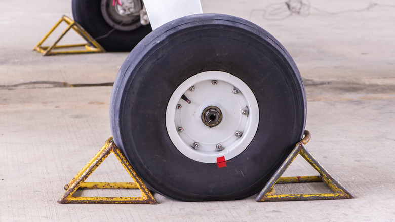 A close up of airplane tire with a red dot.